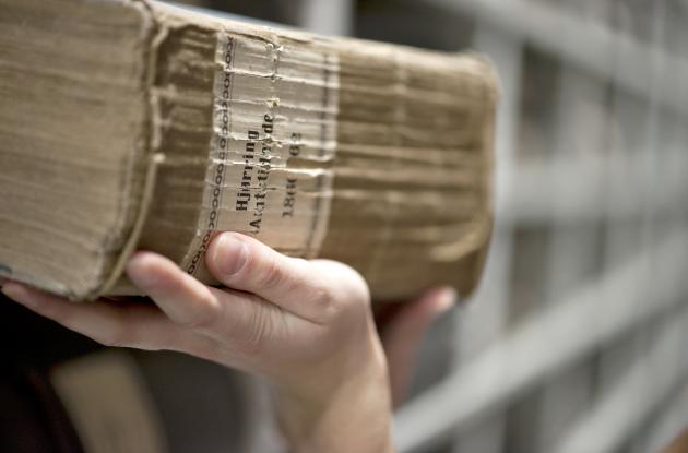 Hardcover newspaper is lifted off the shelf