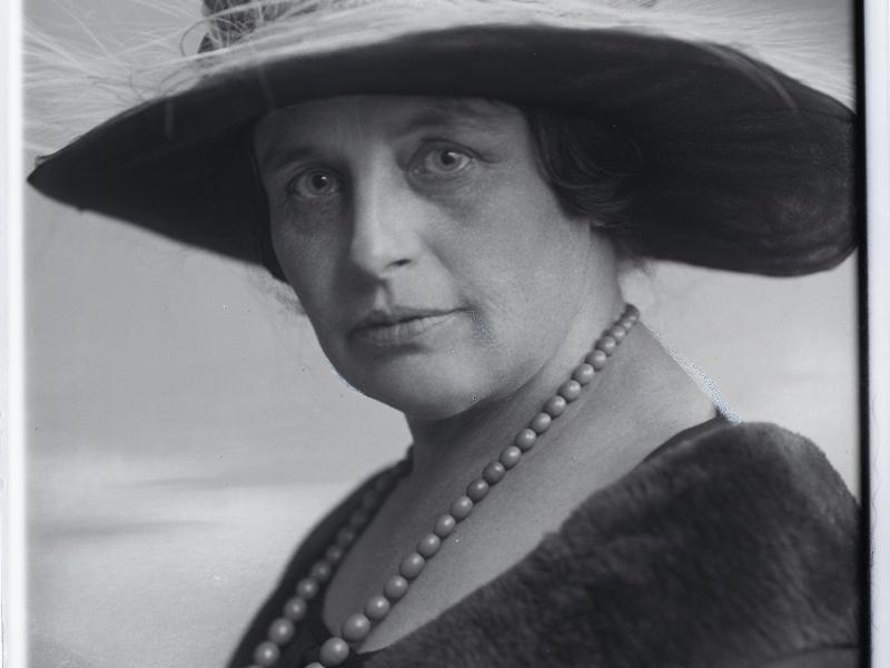 Woman wearing pearls and hat